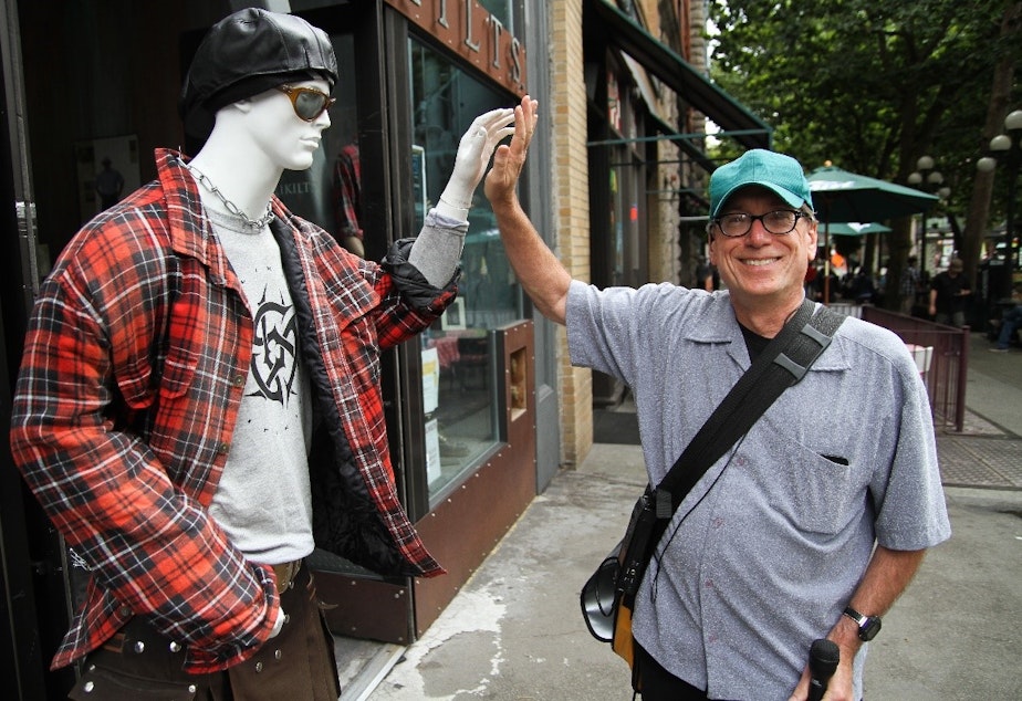 caption: Ross Reynolds having some fun while reporting a story in Seattle's Pioneer Square.