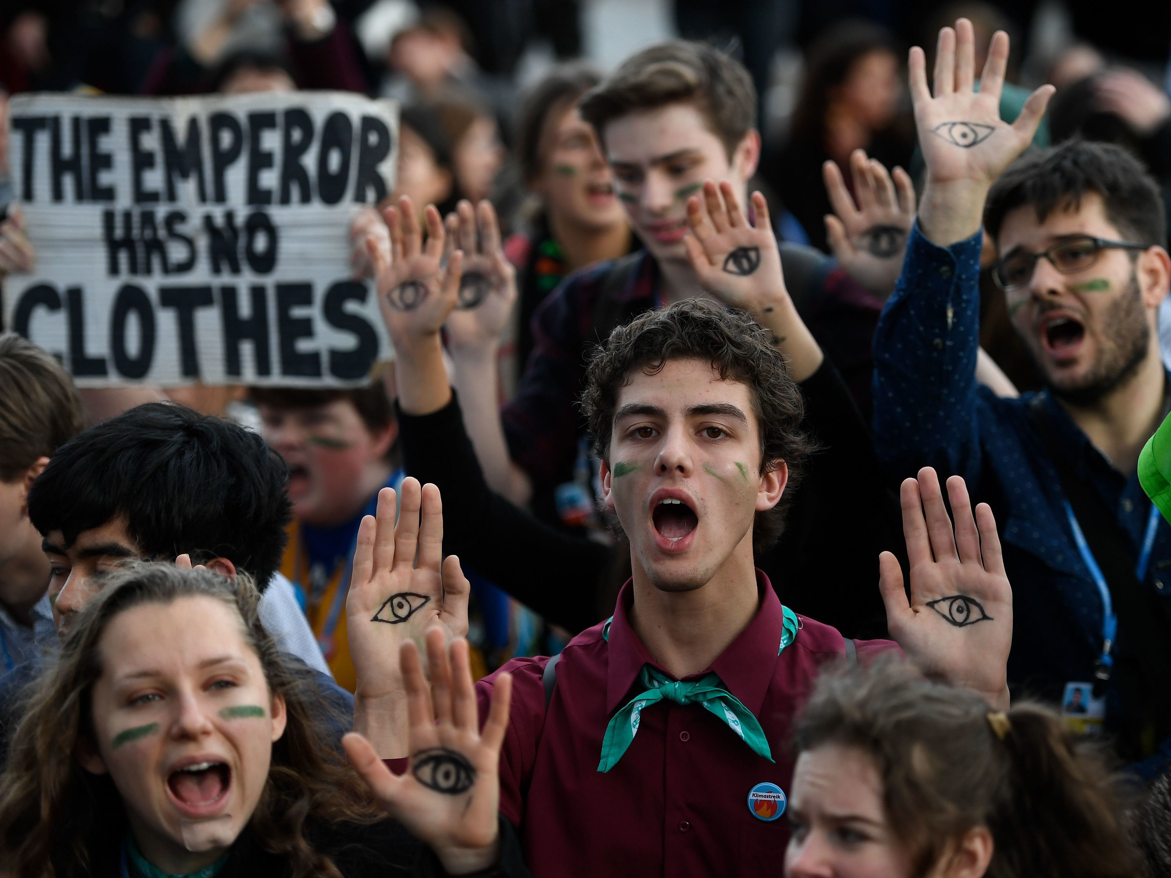 caption: Demonstrators take part in a protest on climate emergency outside the U.N. Climate Change Conference COP25 in Madrid on Friday.