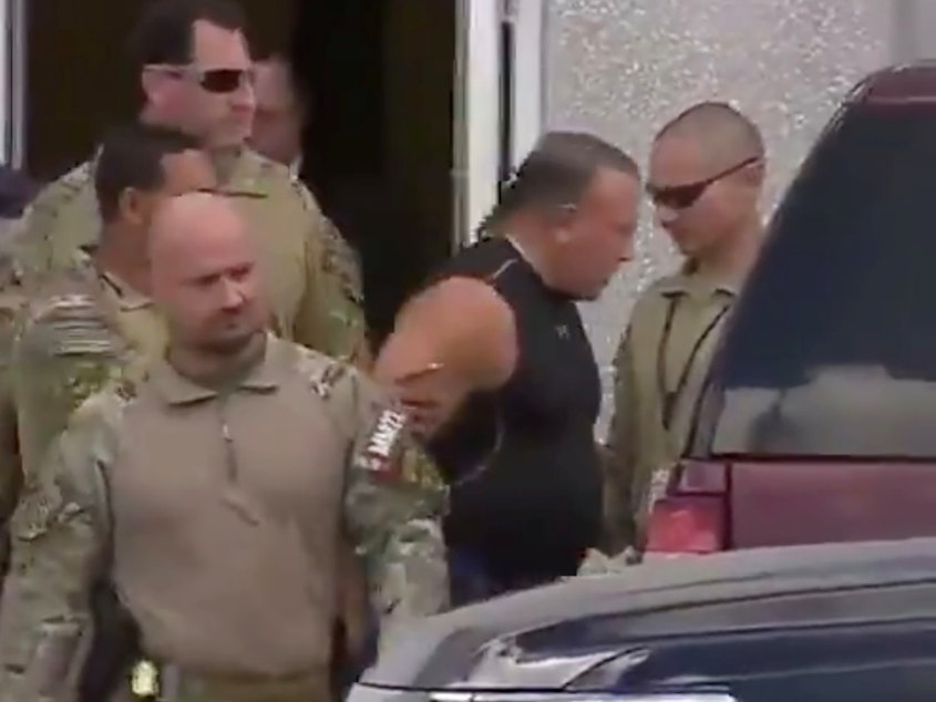 caption: Cesar Altieri Sayoc faces a number of federal charges after the FBI accused him of sending improvised explosive devices to high-profile targets last week. He's seen here being escorted from an FBI facility in Miramar, Fla., on Friday.