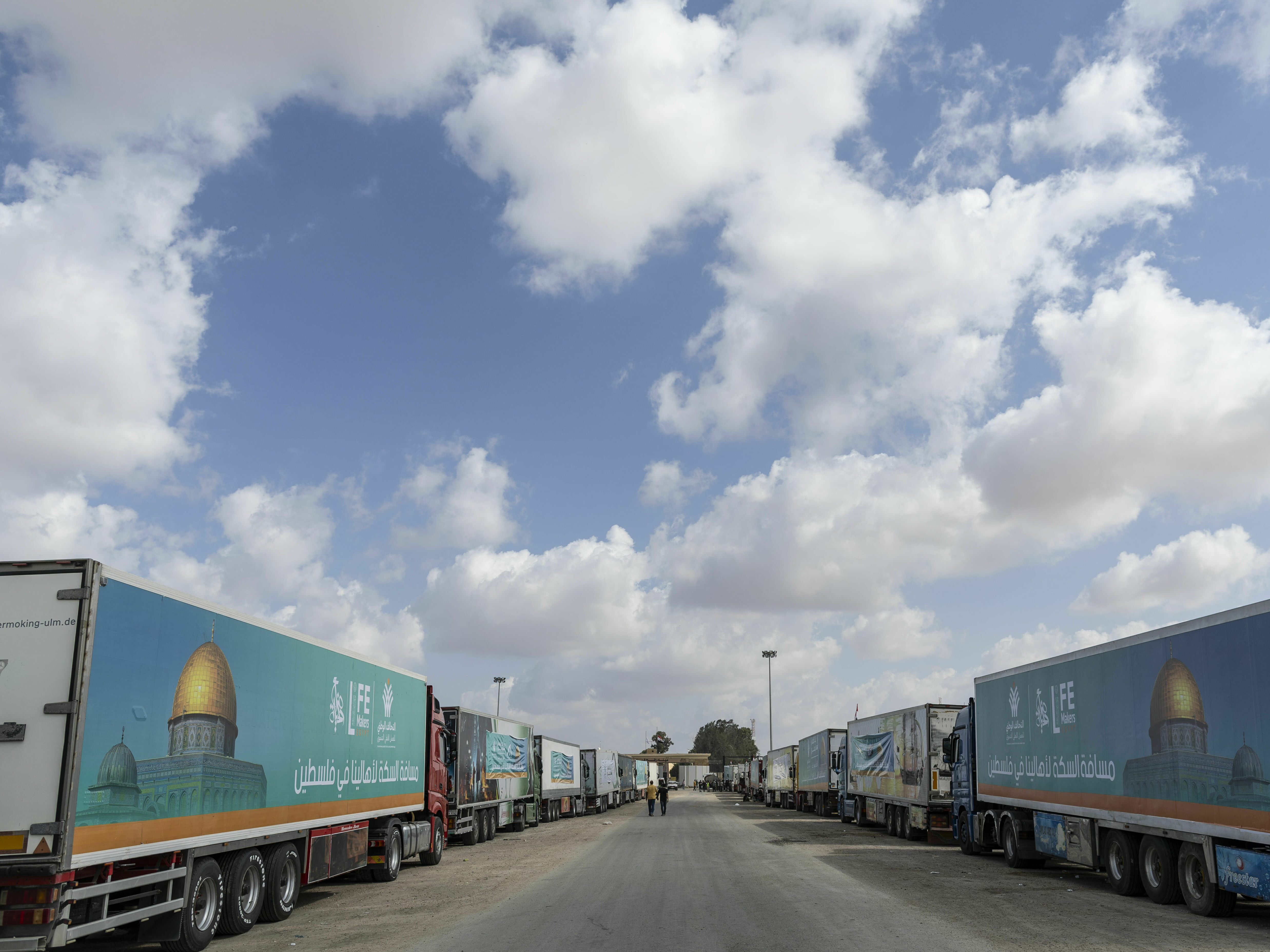 caption: Aid convoy trucks wait at the Rafah border crossing for clearance to enter Gaza on Thursday in North Sinai, Egypt. The aid convoy, organized by a group of Egyptian NGOs, set off Saturday from Cairo for the Gaza-Egypt border crossing at Rafah.