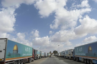 caption: Aid convoy trucks wait at the Rafah border crossing for clearance to enter Gaza on Thursday in North Sinai, Egypt. The aid convoy, organized by a group of Egyptian NGOs, set off Saturday from Cairo for the Gaza-Egypt border crossing at Rafah.