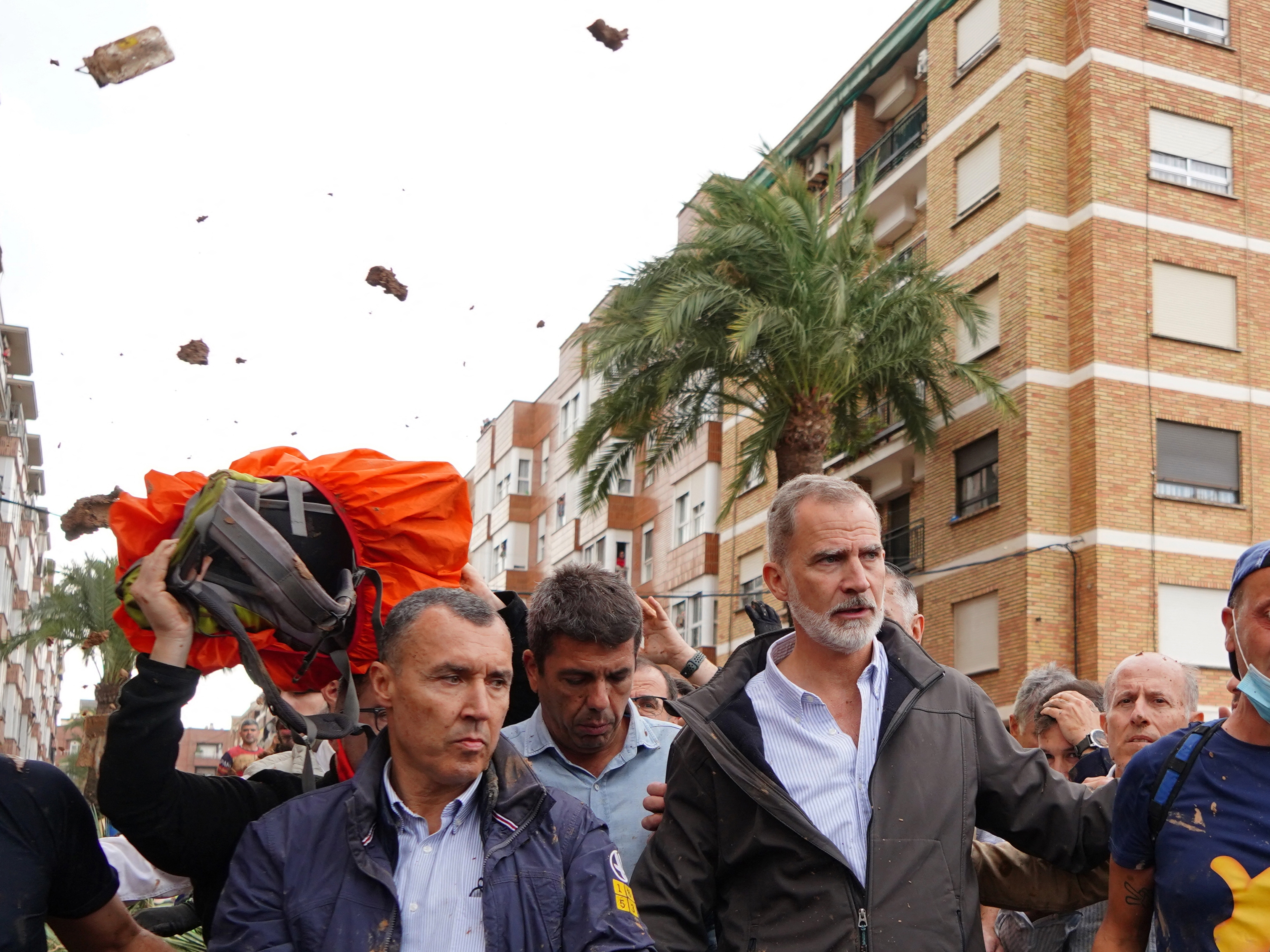 caption: King Felipe VI of Spain is heckled by angry residents who throw mud and objects during his visit to Paiporta, in the region of Valencia, eastern Spain, on November 3, 2024, in the aftermath of devastating deadly floods.