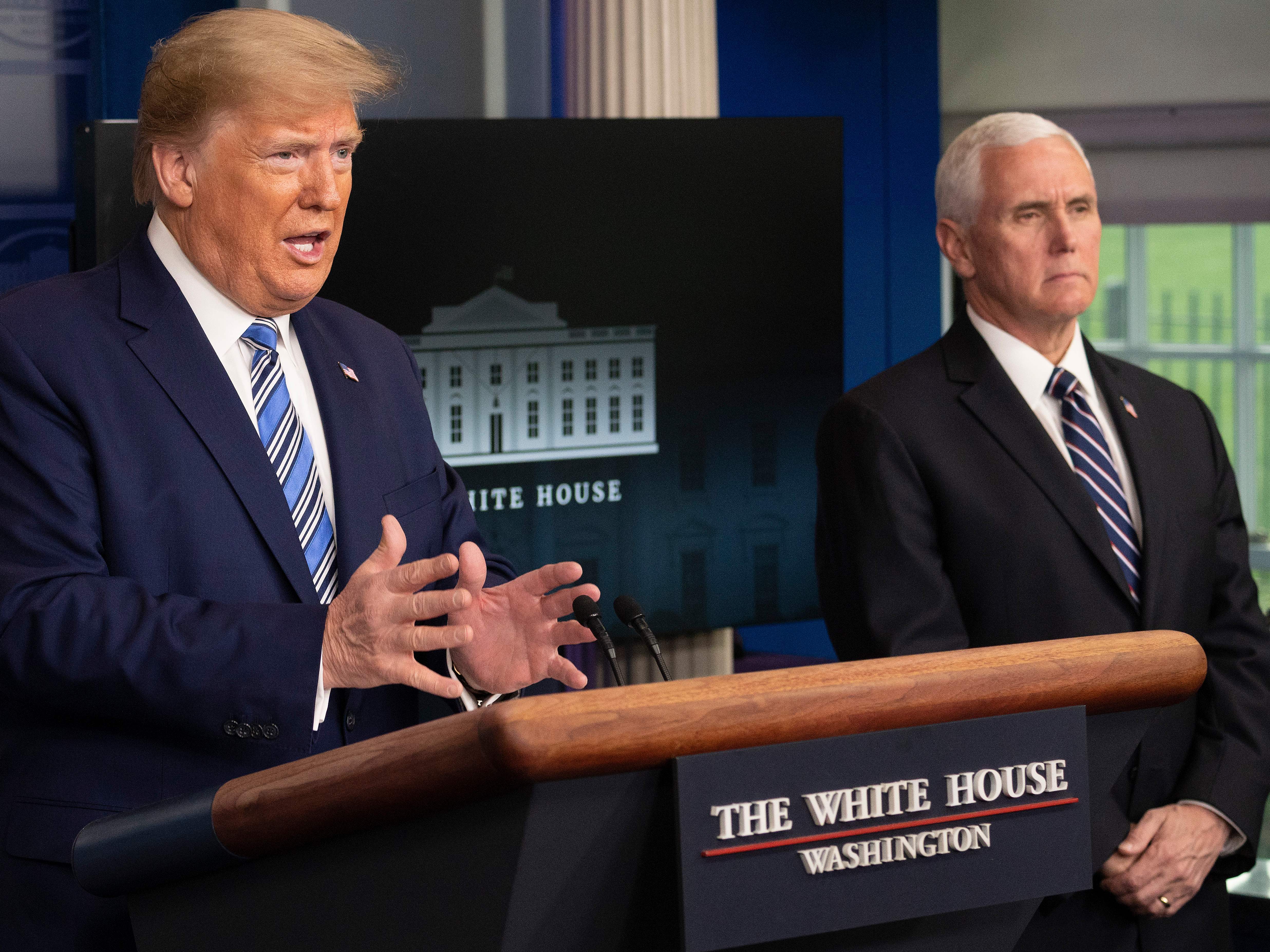caption: President Trump speaks as Vice President Pence looks on during a coronavirus task force press briefing on Sunday.
