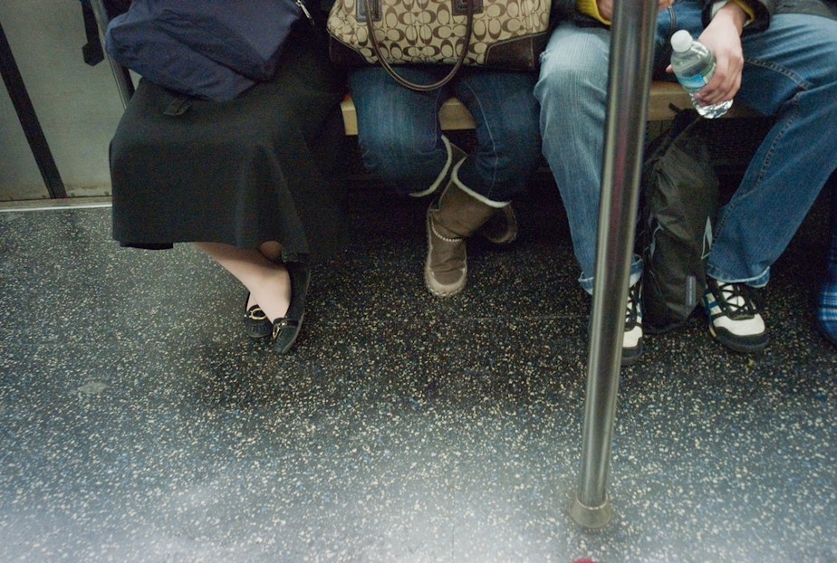 caption: 'Manspreading' on the New York City subway.