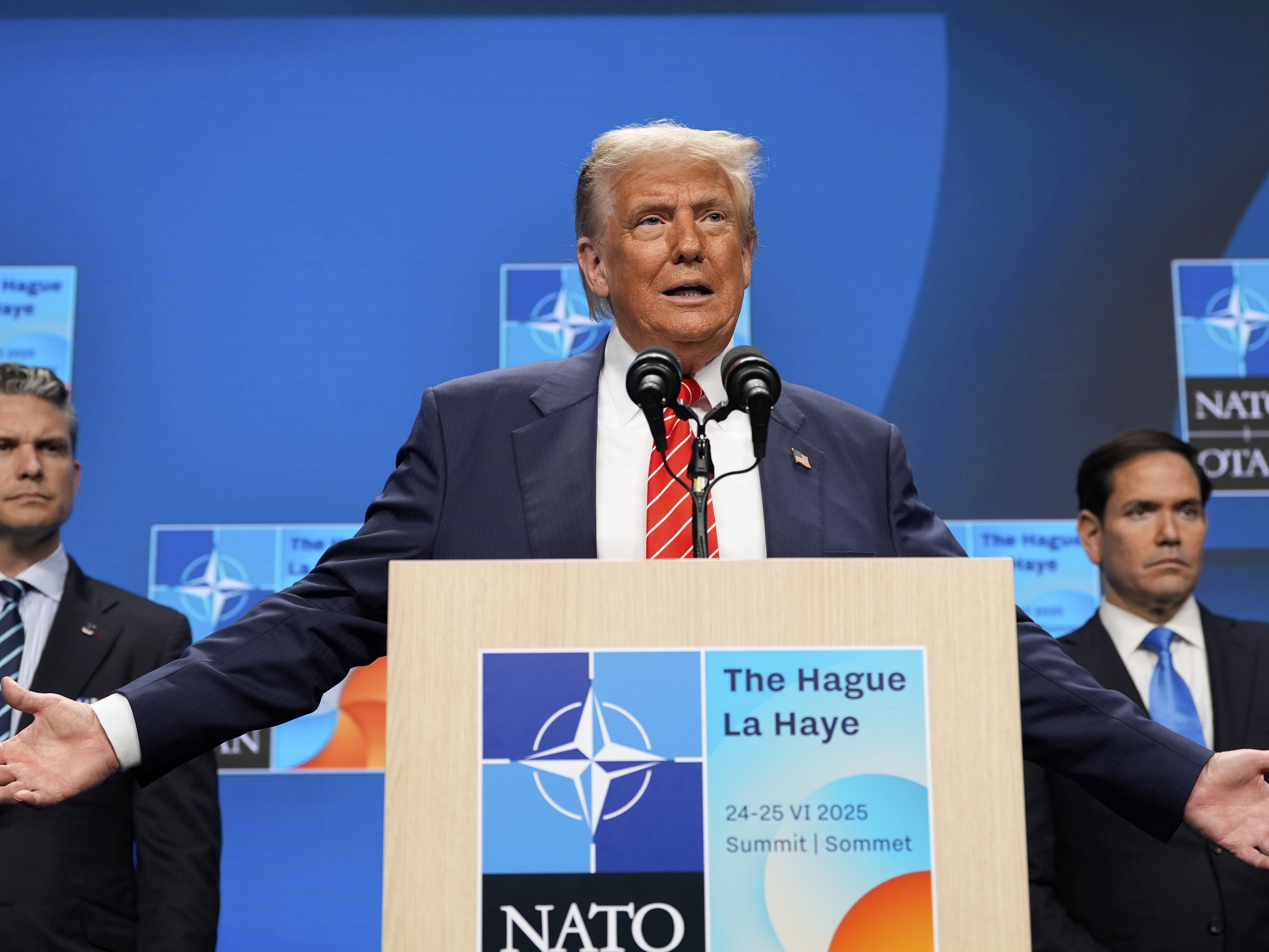 caption: President Donald Trump speaks during a media conference at the end of the NATO summit as Secretary of State Marco Rubio, right, and Defense Secretary Pete Hegseth listen, in The Hague, Netherlands, Wednesday, June 25, 2025.