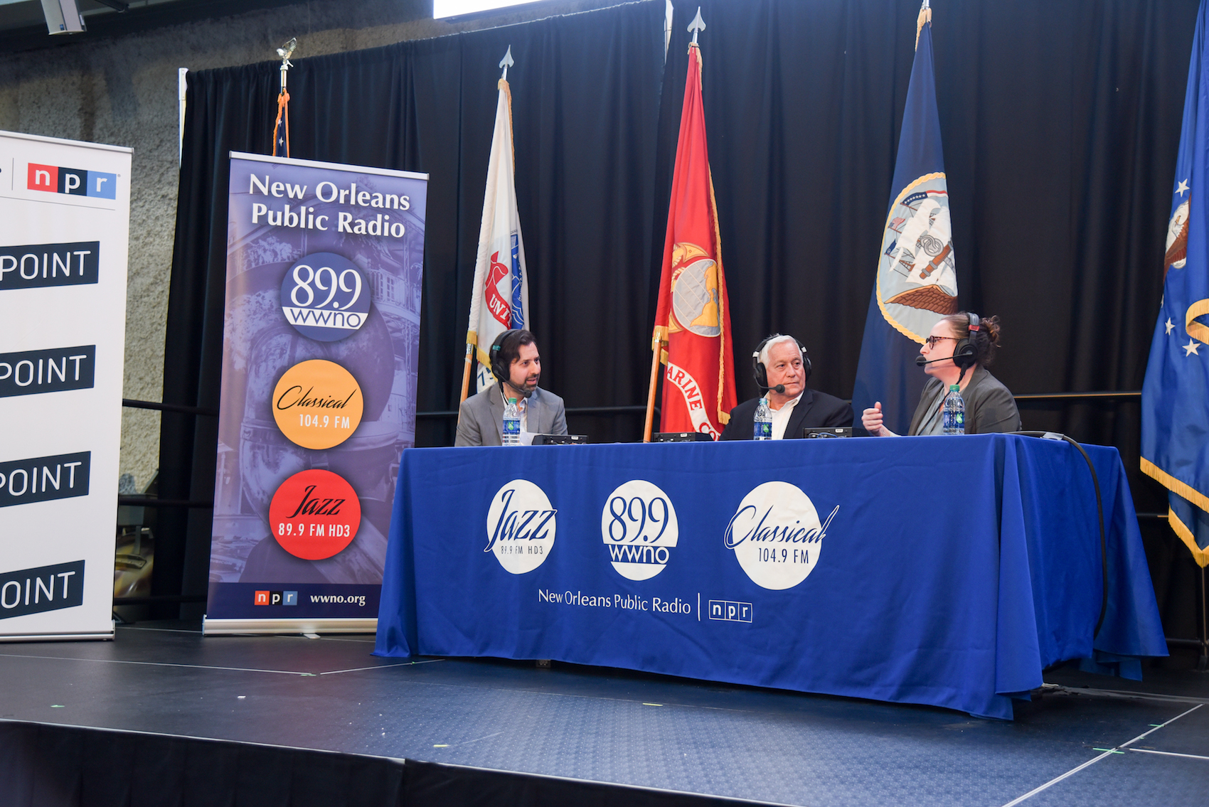 caption: Walter Isaacson (middle) and Gemma Birnbaum join David Folkenflik at The National WWII Museum. (Tracie Morris Schaefer for WWNO)