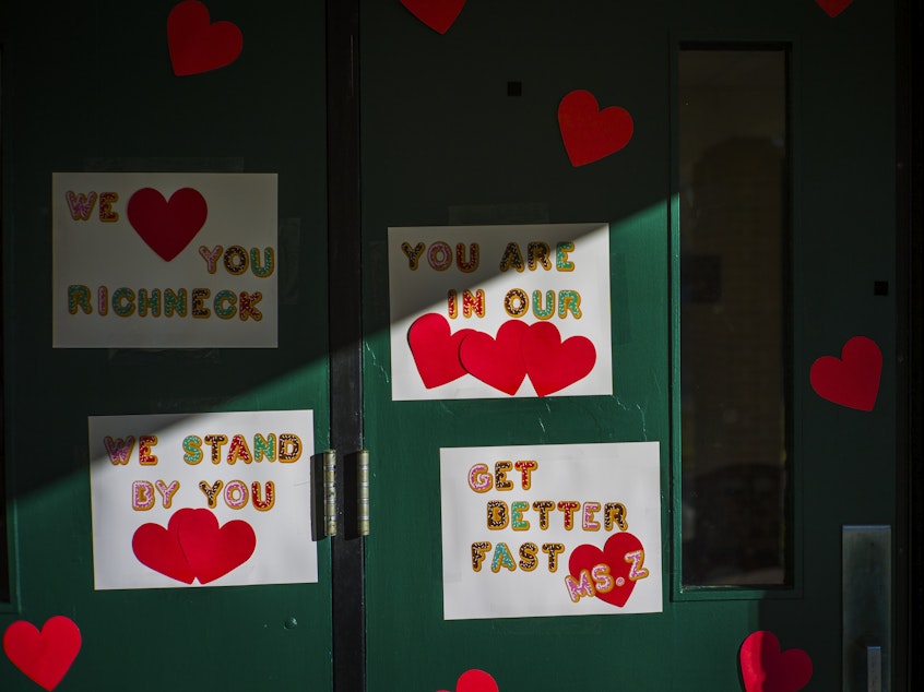 caption: Messages of support for teacher Abby Zwerner, who was shot by a 6-year-old student, grace the front door of Richneck Elementary School Newport News, Va. on Jan. 9.