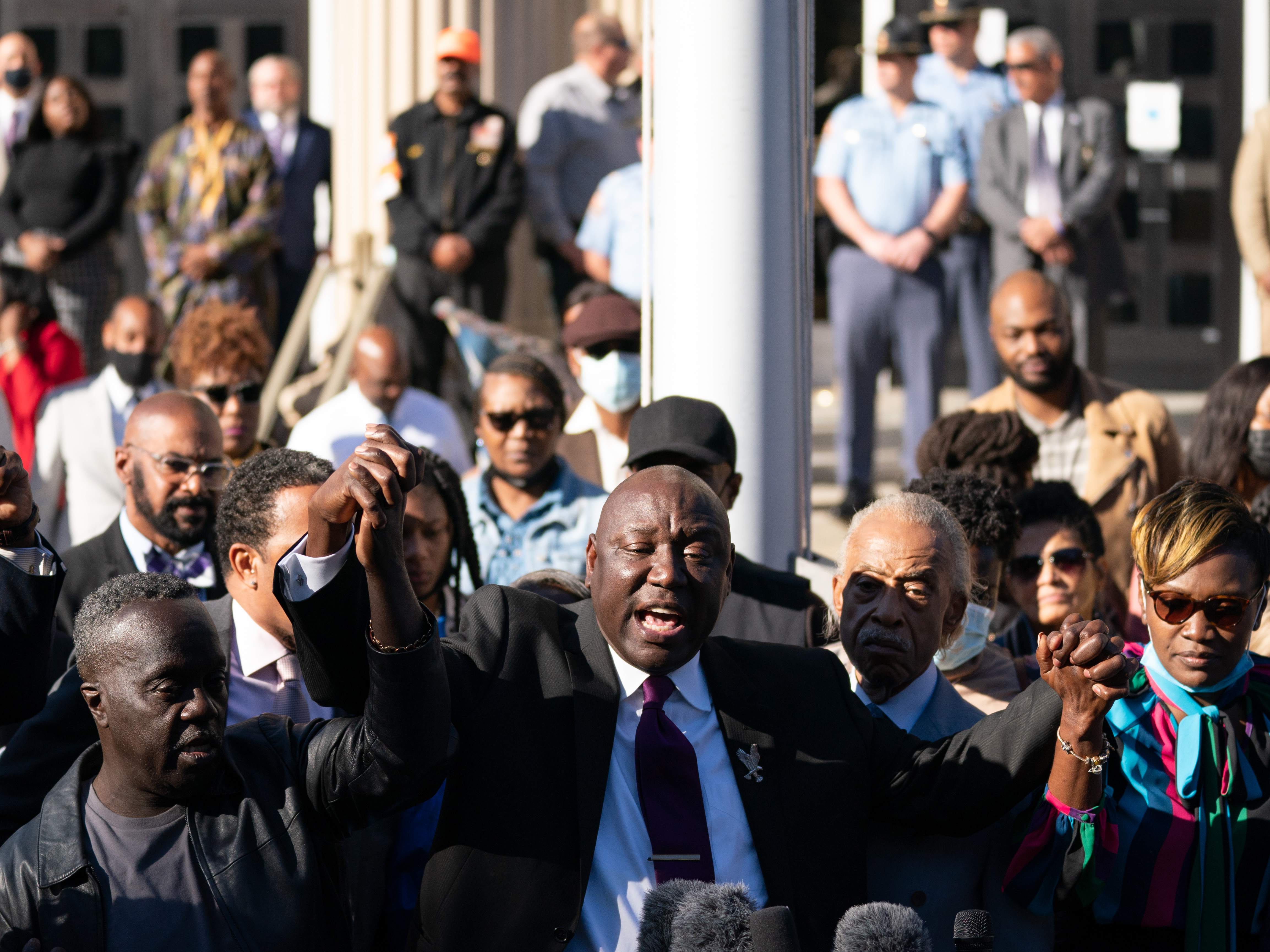 caption: From left to right: Marcus Arbery, father of Ahmaud Arbery; attorney Ben Crump; Rev. Al Sharpton; Wanda Cooper-Jones, mother of Ahmaud Arbery; and attorney Lee Merritt address the media following guilty verdicts for the defendants in the trial of the killers of Ahmaud Arbery on Wednesday in Brunswick, Ga.