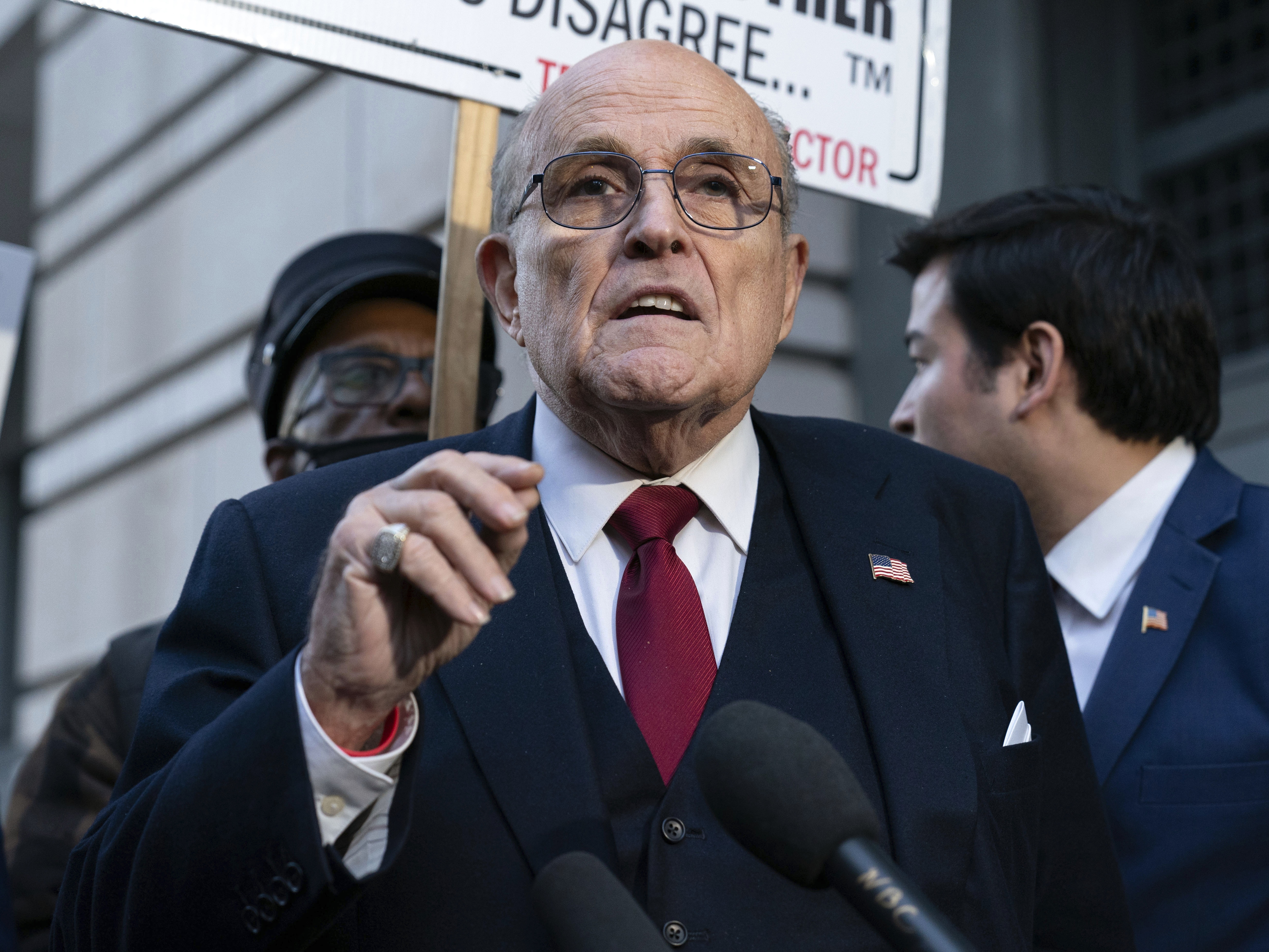 caption: Rudy Giuliani speaks during a news conference outside federal court in Washington, Dec. 15, 2023.