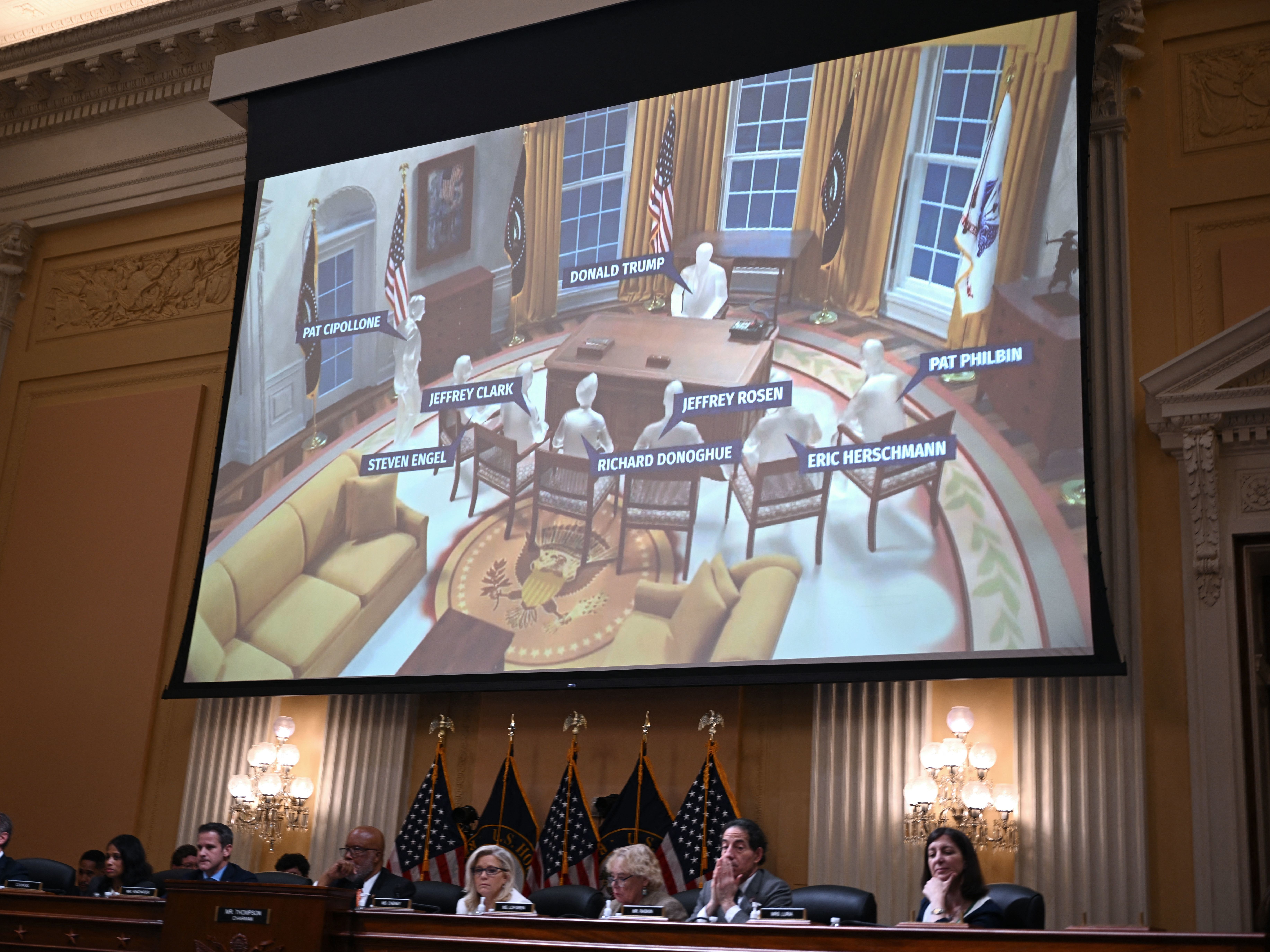 caption: An illlustration of a meeting at the Oval Office of the White House appears onscreen during a hearing by the House select committee to investigate the Jan. 6 Capitol attack in Washington on Thursday.