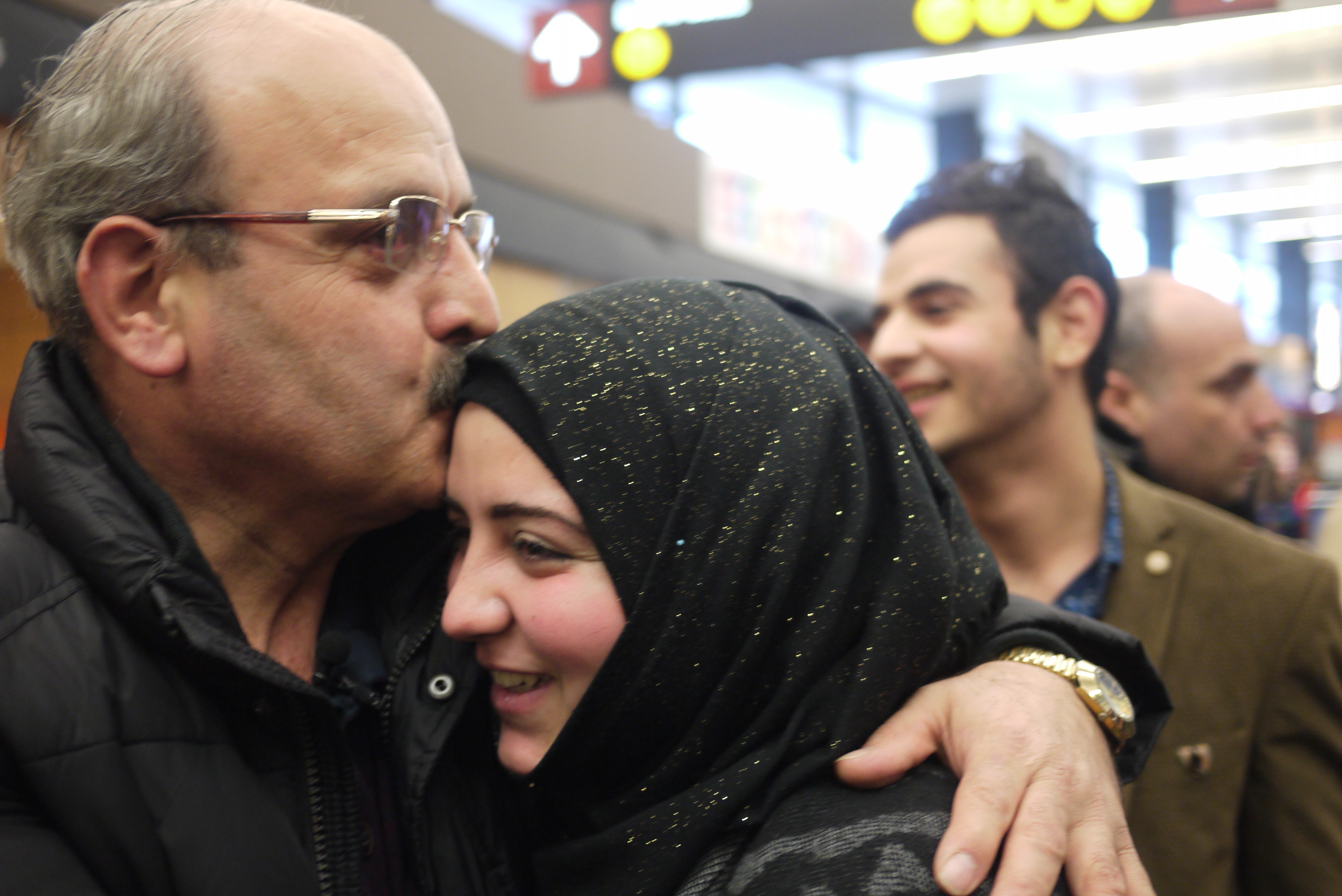caption: Ahmad Al Halabi and daughter, Jaidaa, reunite at Sea-Tac Airport.