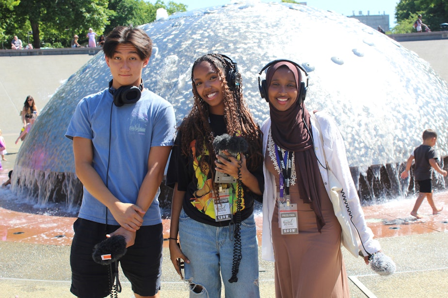 caption: Phillip Zhou, Eliham Mohammed and Jehan Hashi pose while recording audio at Seattle Center on July 14, 2023.