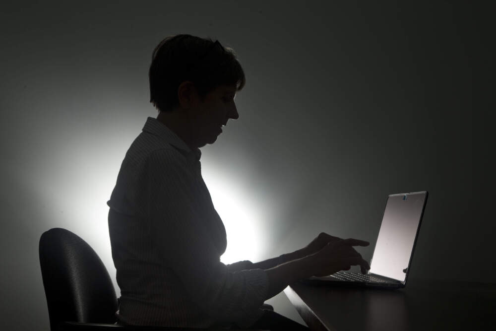 caption: A woman on her laptop in Miami. (Wilfredo Lee/AP)