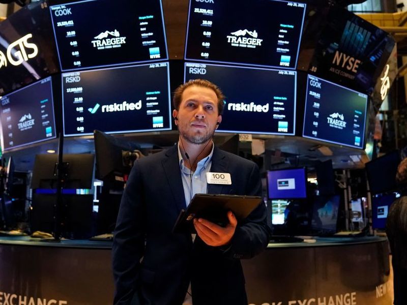 caption: Traders work on the floor at the New York Stock Exchange this summer. Members of Congress are required to disclose their stock transactions under a law known as the STOCK Act, but an outside ethics group filed complaints noting that some lawmakers are violating the rules.