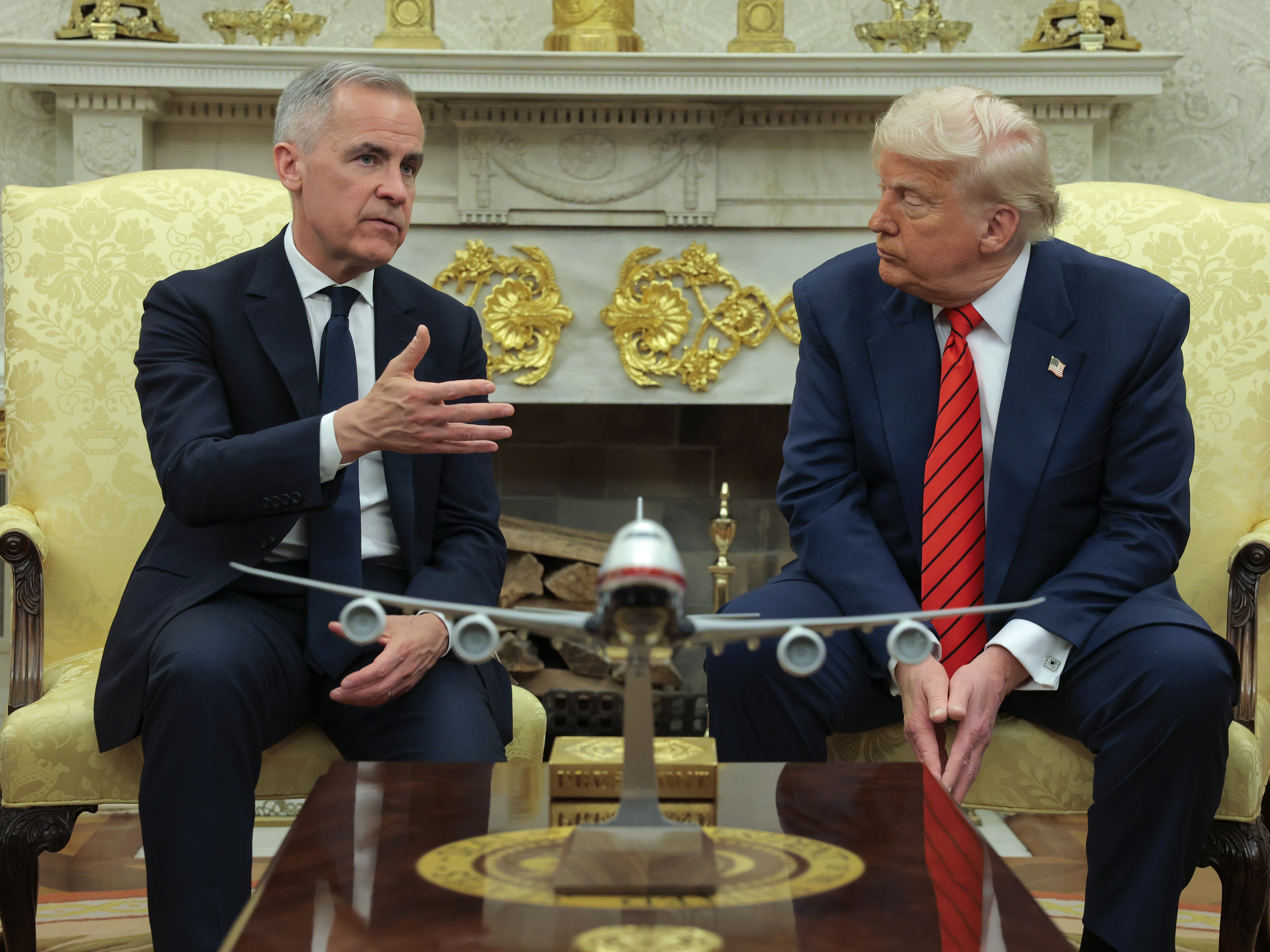 caption: President Trump meets with Canadian Prime Minister Mark Carney in the Oval Office at the White House in Washington, D.C., on May 6, 2025. Carney's government said on Sunday it would scrap a tax on U.S. tech companies after Trump threatened higher tariffs on Canadian goods.
