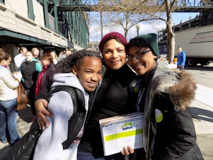 caption: Niah, April and Jasmyne Sims pose outside Safeco Field before the Bernie Sanders rally Friday in Seattle.