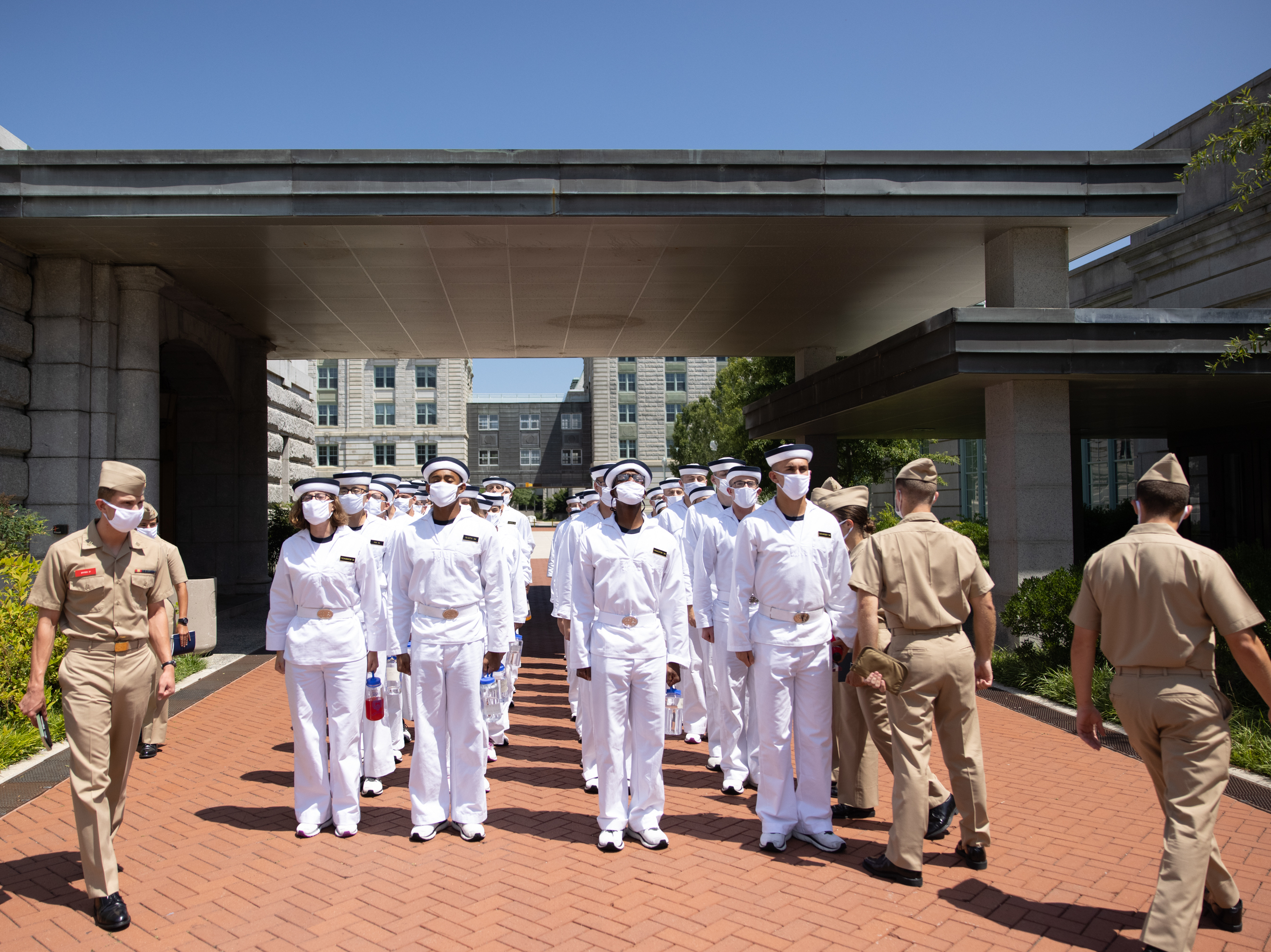 caption: Plebe Summer Detailers lead a company of incoming freshman students, or "plebes," at the U.S. Naval Academy in Annapolis, Md.