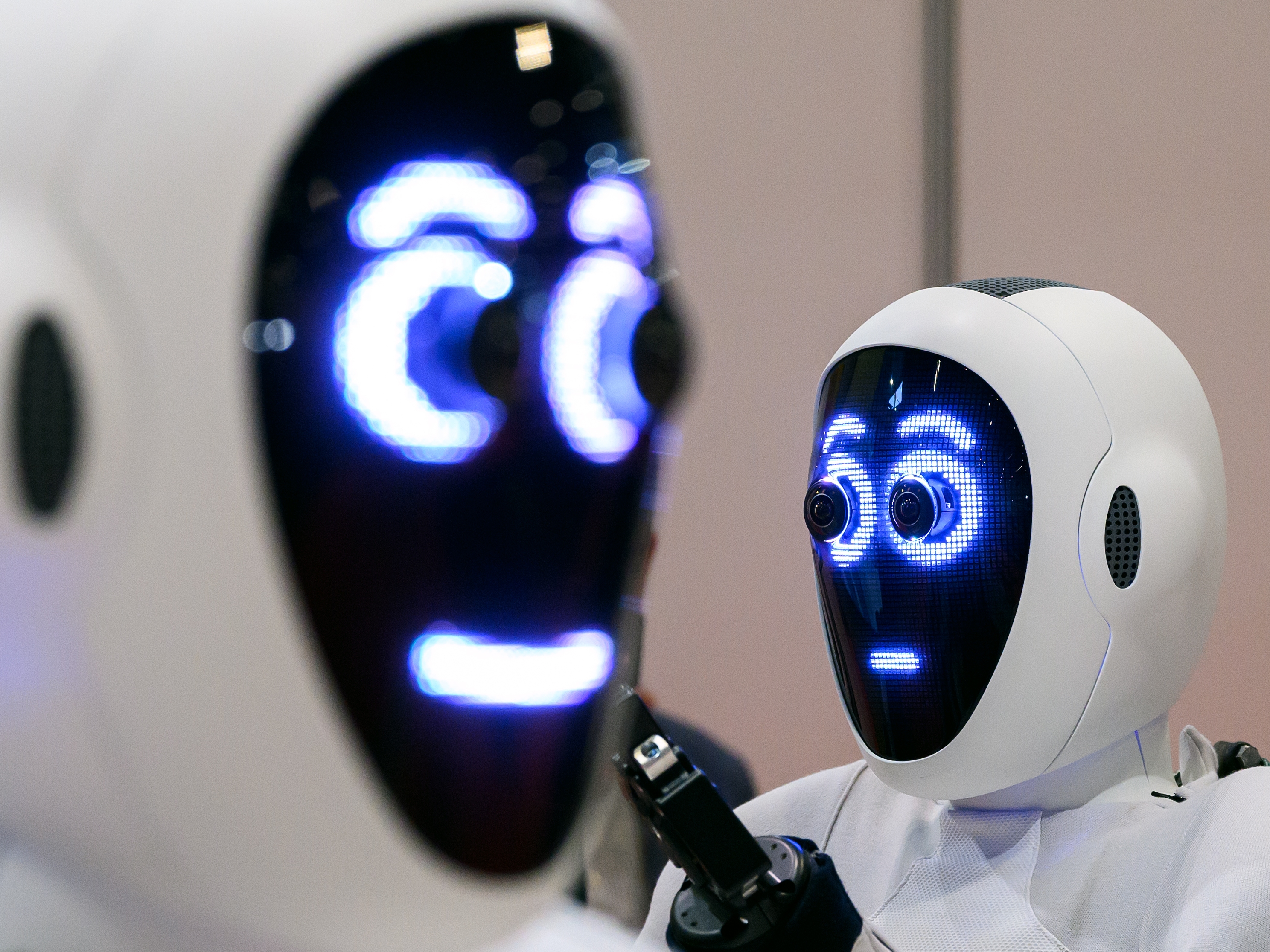 caption: A pair of 1X androids are displayed at the International Conference on Robotics and Automation (ICRA) at ExCel on May 30, 2023, in London.