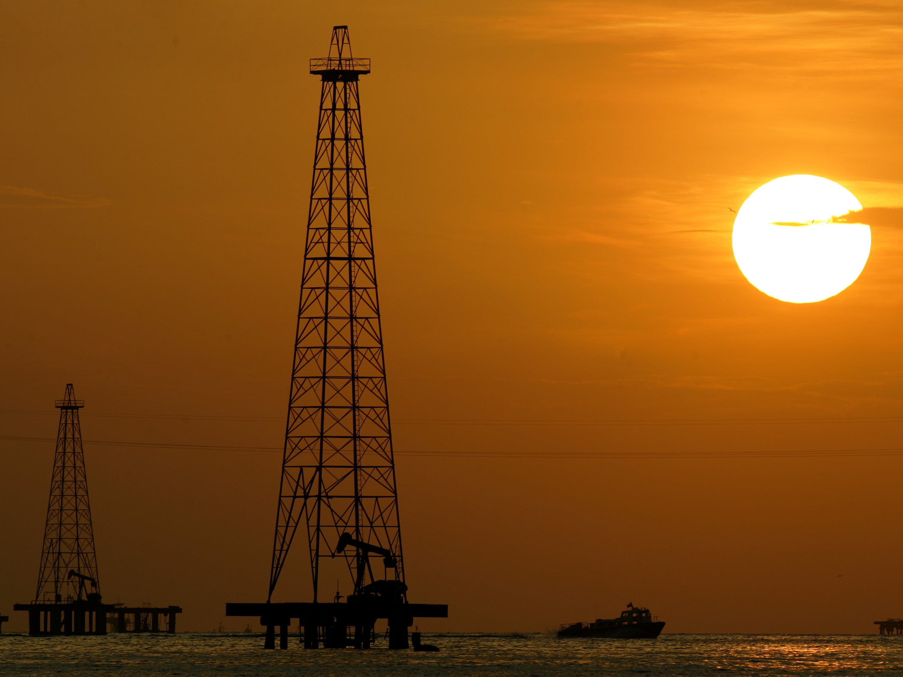 caption: Oil drills in Maracaibo Lake in Venezuela's oil rich Zulia state. The U.S. is renewing sanctions on Venezuela's oil industry.