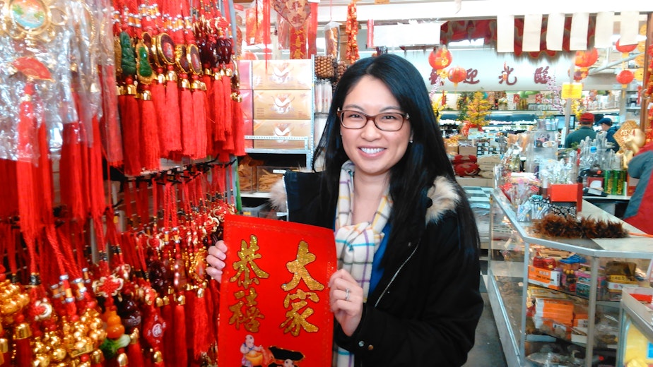 caption: Leeching Tran with Lunar New Year decorations at Viet Wah Supermarket. 