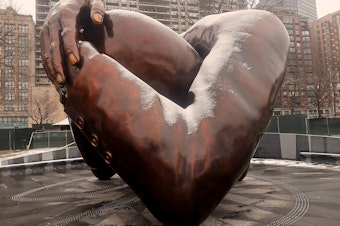 caption: The Embrace, the new memorial sculpture in Boston made in tribute to Martin Luther King Jr. and Coretta Scott King, was unveiled on Friday.