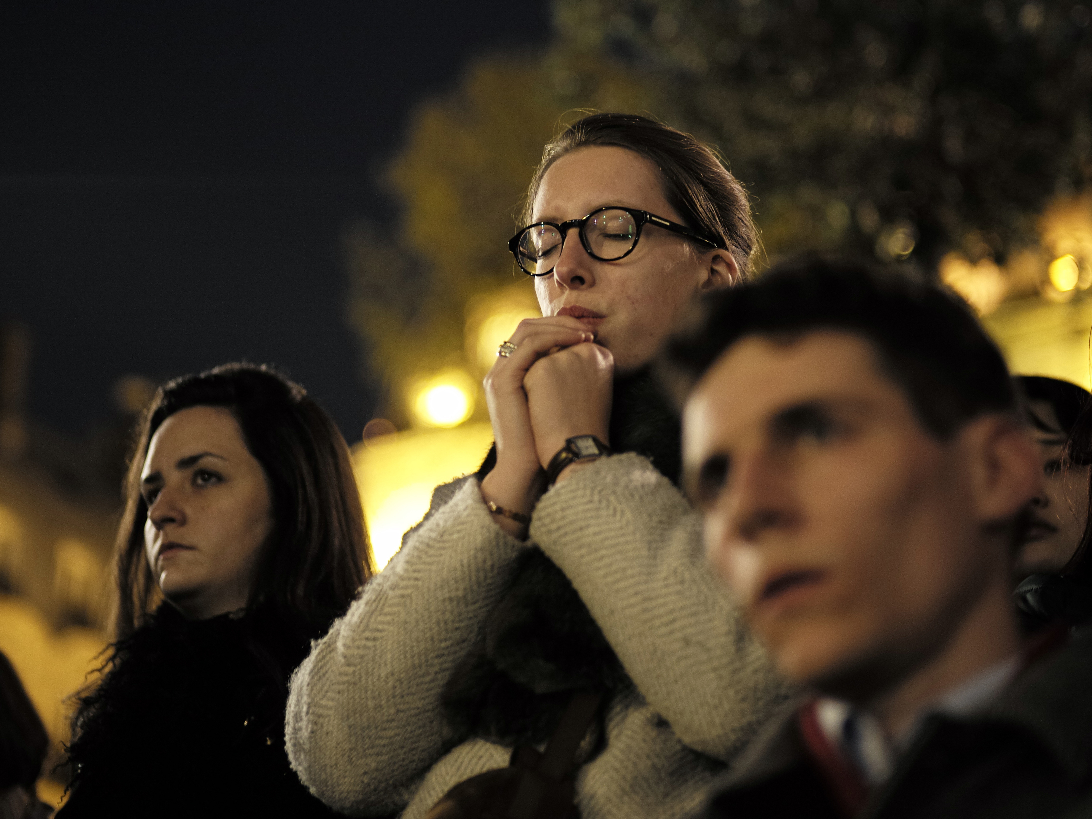 caption: People attend a vigil in Paris on Tuesday following the devastating fire that destroyed much of the beloved Notre Dame Cathedral.