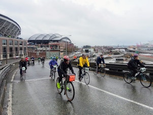 caption: On Sunday, 7,000 cyclists braved wind and rain to get the last ride across the viaduct.