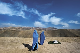 caption: Noor Nisa, 18 (right), was in labor and en route to the hospital with her mother and husband, in Badakhshan Province, Afghanistan, when his car broke down. Lynsey Addario ended up driving Nisa to the hospital, where she delivered a baby girl. November 2009