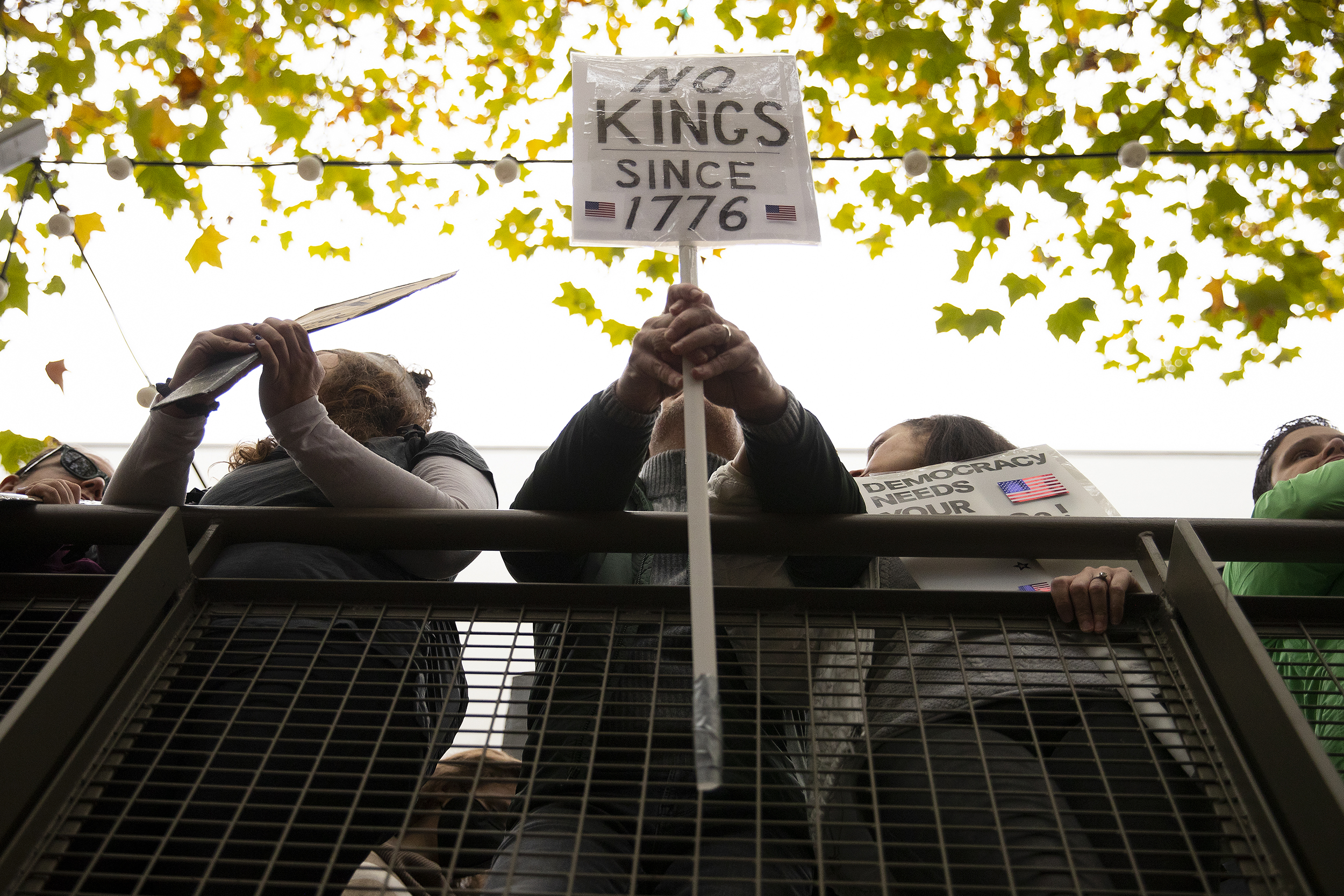 caption: ‘No Kings Since 1776’ reads a sign as protesters gather for the No Kings rally at Seattle Center on Saturday, October 18, 2025, in Seattle, Washington. 