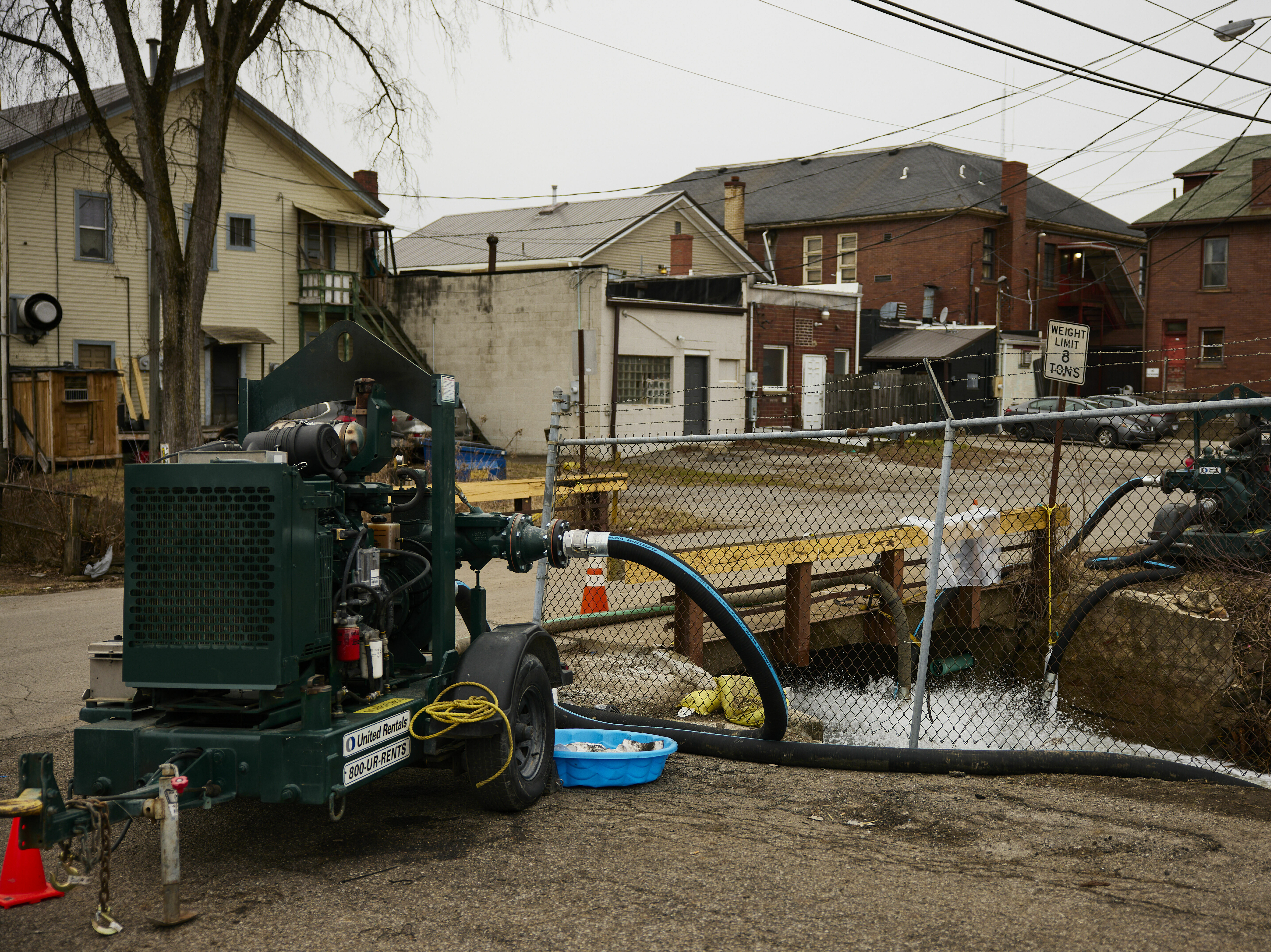 caption: Water is pumped into a creek for aeration in East Palestine, Ohio, on Tuesday, more than a week after a train derailment released toxic chemicals.