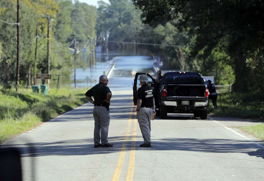 caption: Responders congregate near where two women drowned when they were locked in a Horry County Sheriff's department transport van in Marion County, S.C.