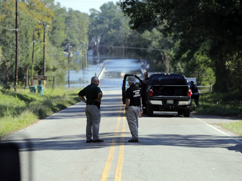 caption: Responders congregate near where two women drowned when they were locked in a Horry County Sheriff's department transport van in Marion County, S.C.