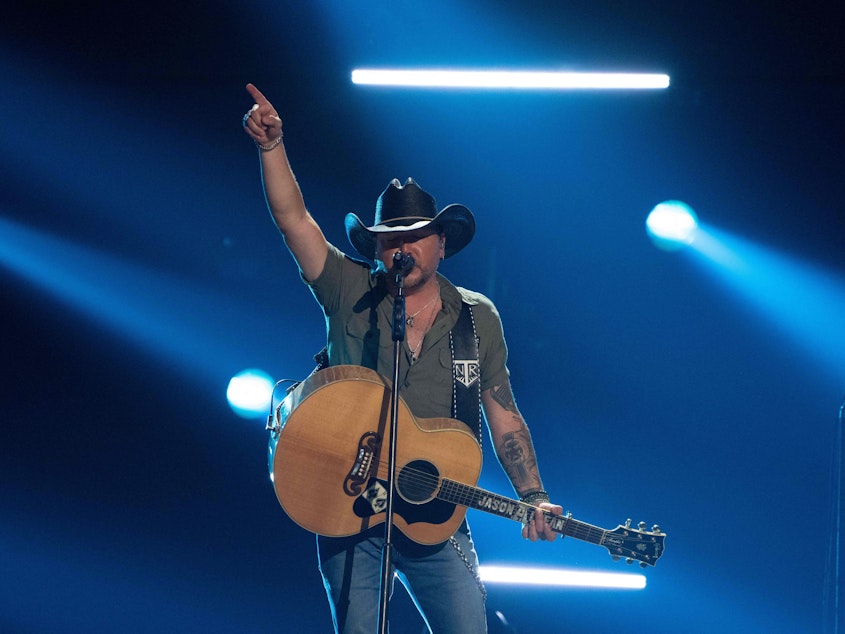 caption: Country music singer Jason Aldean, pictured here performing at the Academy of Country Music Awards in Frisco, Texas in May, is facing a mixed bag of backlash and praise for a new music video that openly alludes to vigilante justice.