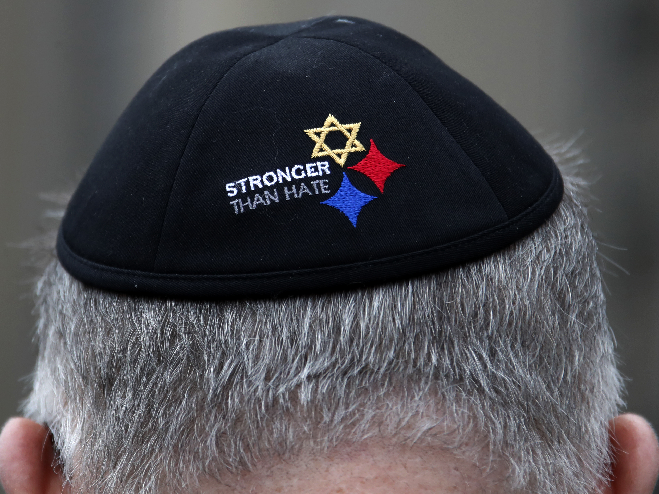 caption: A man wearing a Stronger Than Hate yarmulke stands outside the Tree of Life synagogue in Pittsburgh, the site of a shooting that killed 11 worshippers in 2018. Anti-Semitic homicides in the U.S. reached their highest level ever as a result of the shooting.
