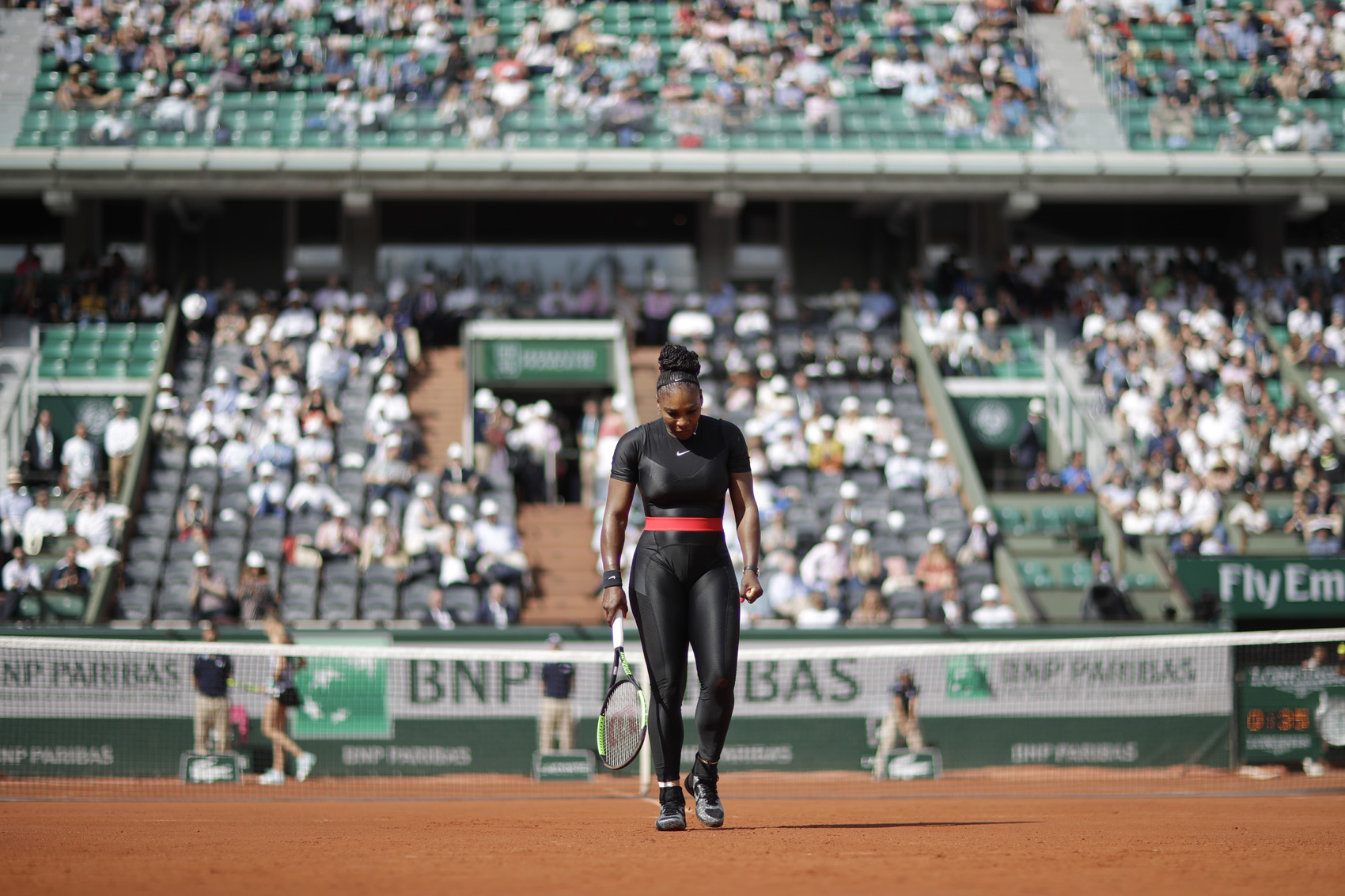 caption: Serena Williams of the U.S. walks back to the baseline after returning a shot against Krystina Pliskova of the Czech Republic during their first round match of the French Open tennis tournament at the Roland Garros stadium in Paris, France, Tuesday, May 29, 2018. (Alessandra Tarantino/AP)