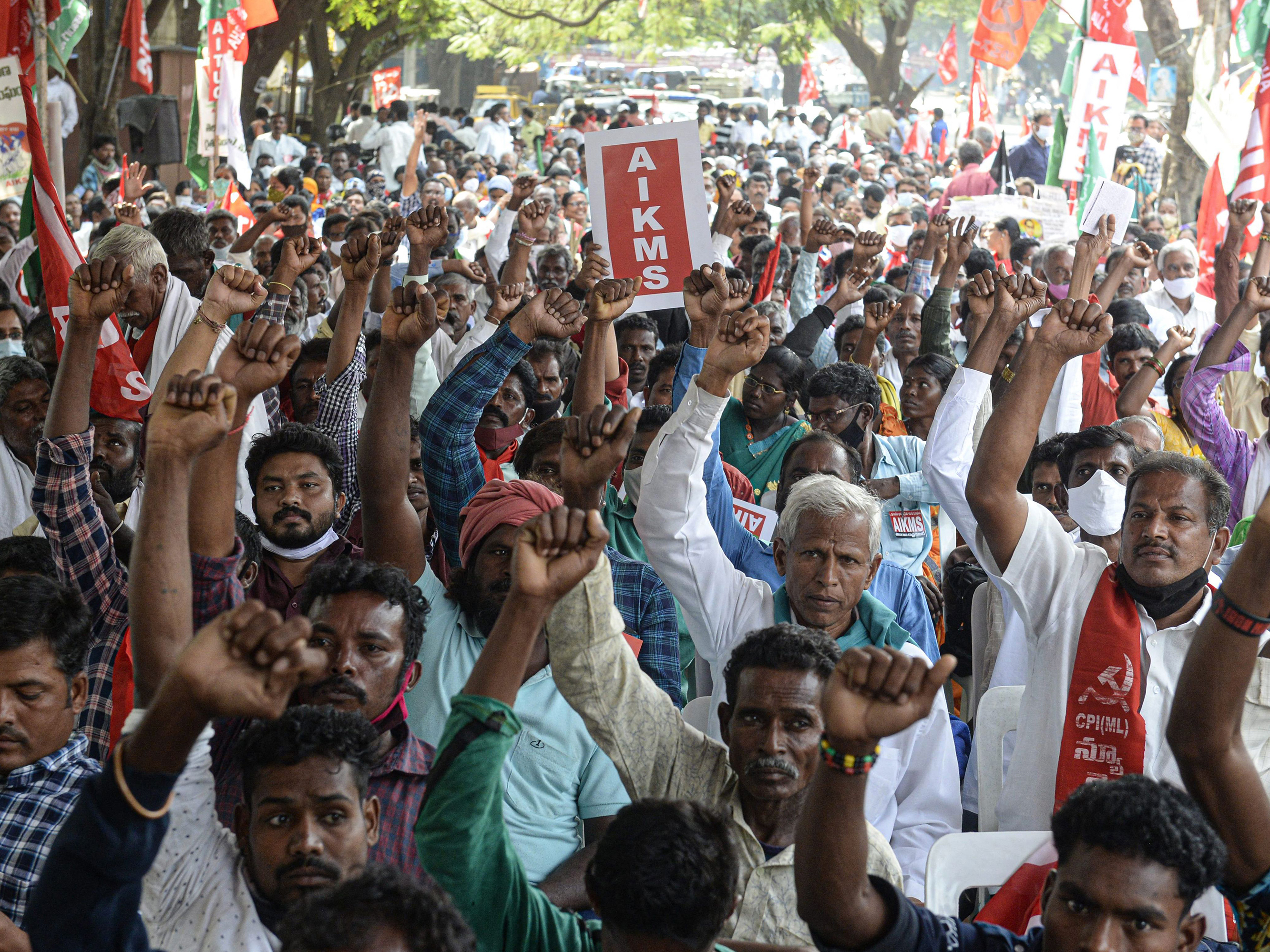 caption: Supporters of All India Kisan Sangharsh Coordination Committee, a group of farmers' organizations, hold flags during a protest to mark one year since the introduction of divisive farm laws and to demand the withdrawal of the Electricity Amendment Bill, in Hyderabad, India, on Thursday.