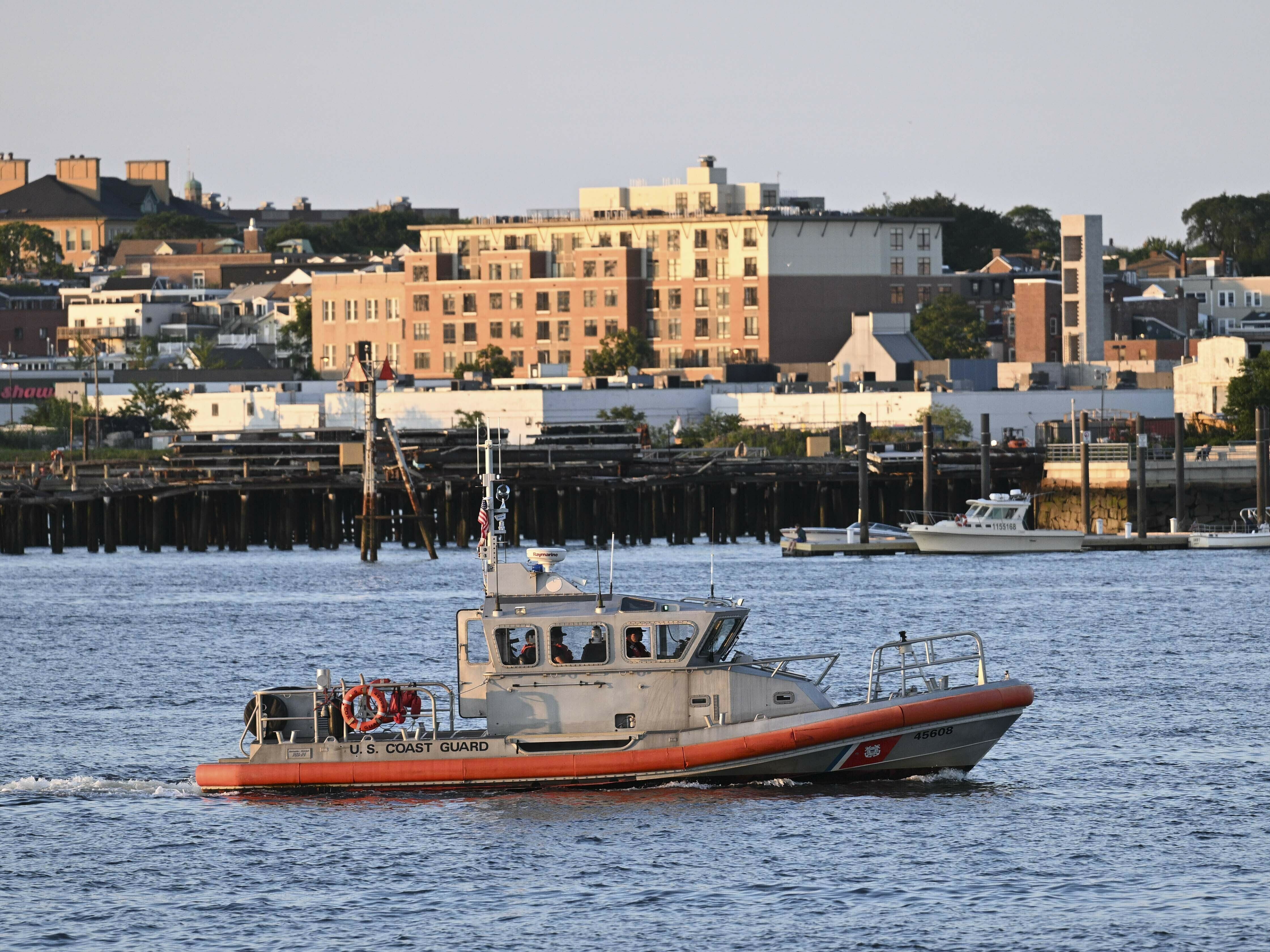 caption: A boat near the U.S. Coast Guard base in Boston, Mass., on Wednesday, where rescue teams are racing to find a missing submersible with five people on board.