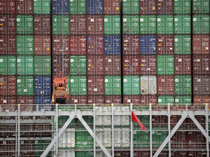 caption: Cargo containers are stacked on a ship at California's Port of Los Angeles.