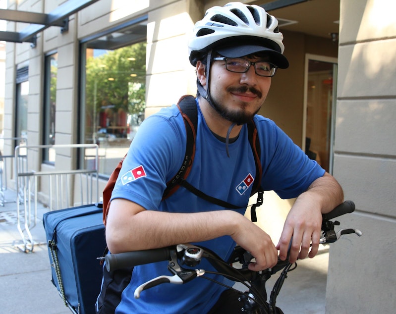 caption: Jesus Cabanillo, pizza delivery rider for the Belltown Domino's in Seattle.
