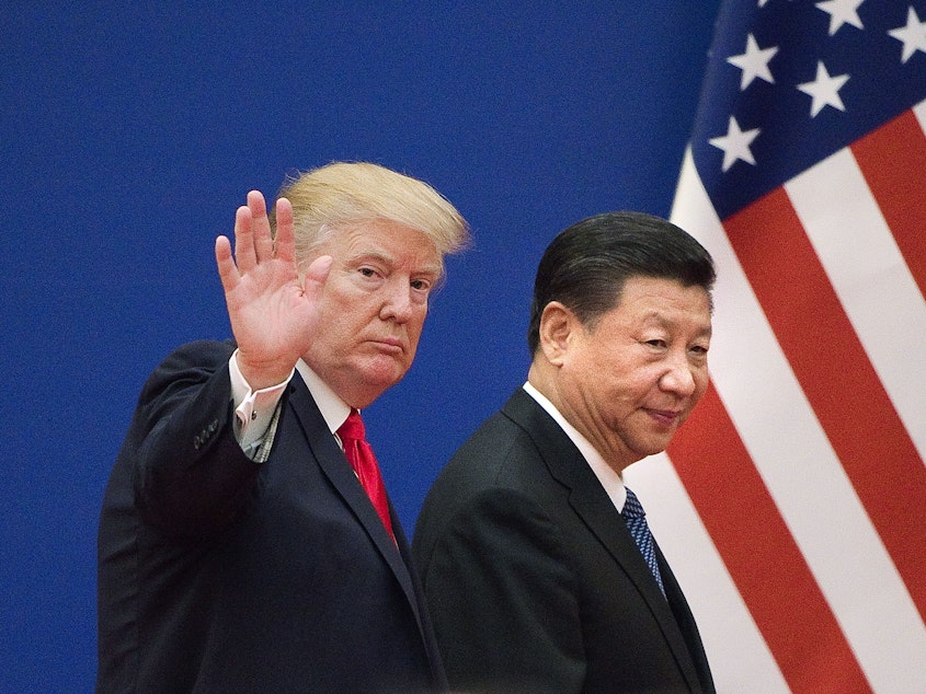 caption: President Trump and China's leader Xi Jinping leave a business leaders event in Beijing in 2017. Relations involving trade and other areas between the two countries have deteriorated.