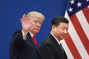 caption: President Trump and China's leader Xi Jinping leave a business leaders event in Beijing in 2017. Relations involving trade and other areas between the two countries have deteriorated.