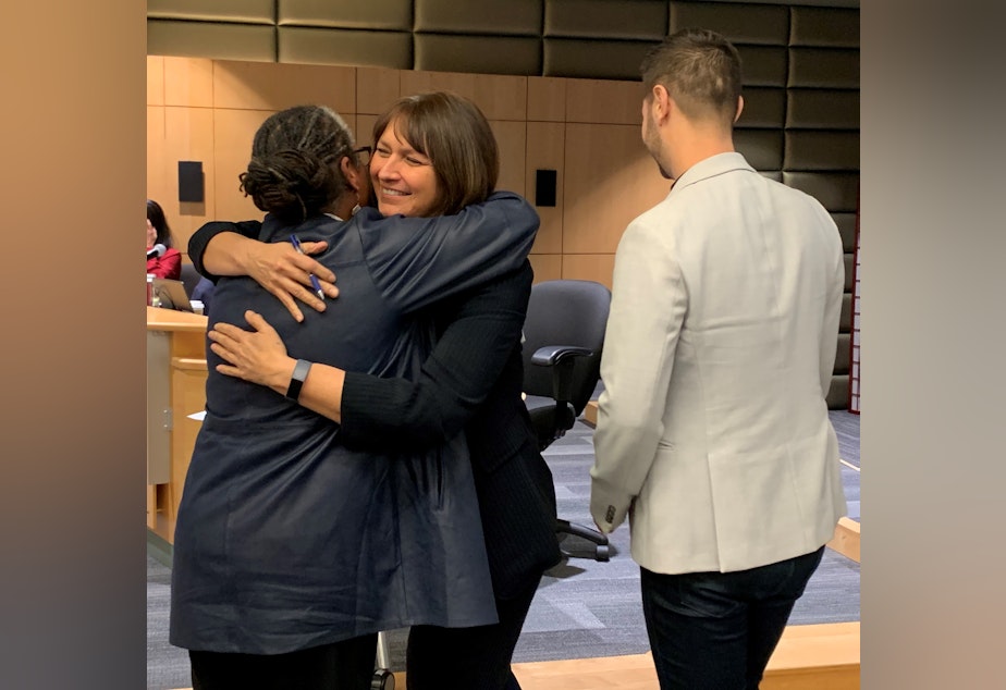 caption: Technology Access Foundation co-founder Trish Millines-Dziko (left) and Seattle Public Schools superintendent Denise Juneau (middle) share an embrace before signing a partnership agreement.