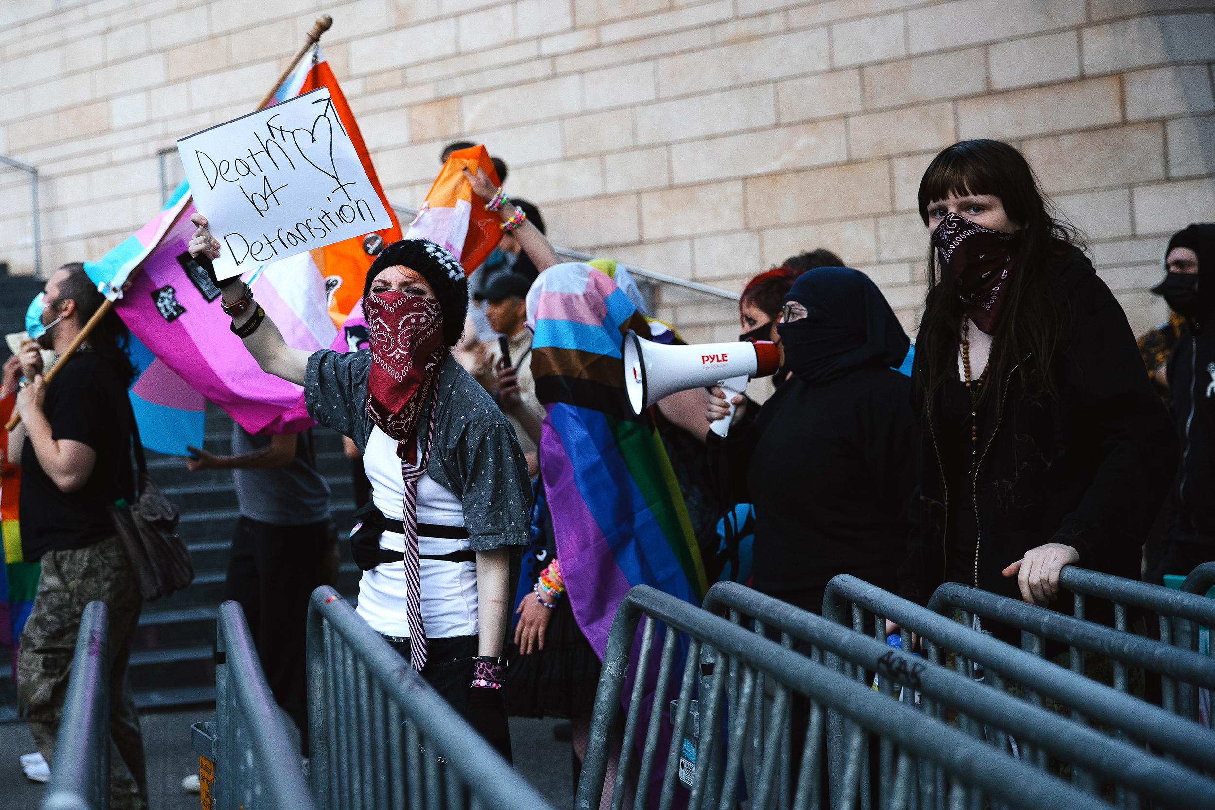 caption: ‘Death b4 Detransition’ reads a sign as counter-protesters march following the fundamentalist Christian group Mayday USA’s ‘Rattle in Seattle’ event, on Tuesday, May 27, 2025, at Seattle City Hall. MayDay USA advocates against trans rights. 