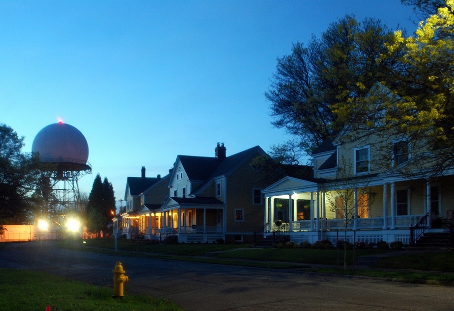caption: Fort Lawton at night. The homes pictured here are on another part of the former Ft Lawton. They were sold at market rate to private buyers in 2015. Zillow places the current value of these homes at over 2 million dollars. In contrast, homes built in another part of the old fort by non-profits like Habitat for Humanity will be affordable for lower income families. Other housing will be for formerly homeless people.