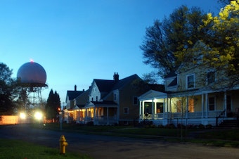 caption: Fort Lawton at night. The homes pictured here are on another part of the former Ft Lawton. They were sold at market rate to private buyers in 2015. Zillow places the current value of these homes at over $2 million. In contrast, homes built in another part of the old fort by nonprofits like Habitat for Humanity will be affordable for lower-income families. Other housing will be for formerly homeless people.