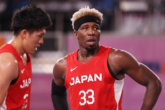caption: Ira Brown of Team Japan looks on during the Men's Pool Round match between Latvia and Japan on Sunday at the Tokyo 2020 Olympic Games. "It's an honor to be Japanese," he said.