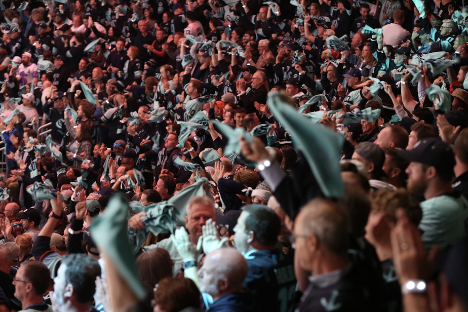 caption: Kraken fans celebrate during a playoff game on April 24th, 2023, at the Climate Pledge Arena in Seattle. 