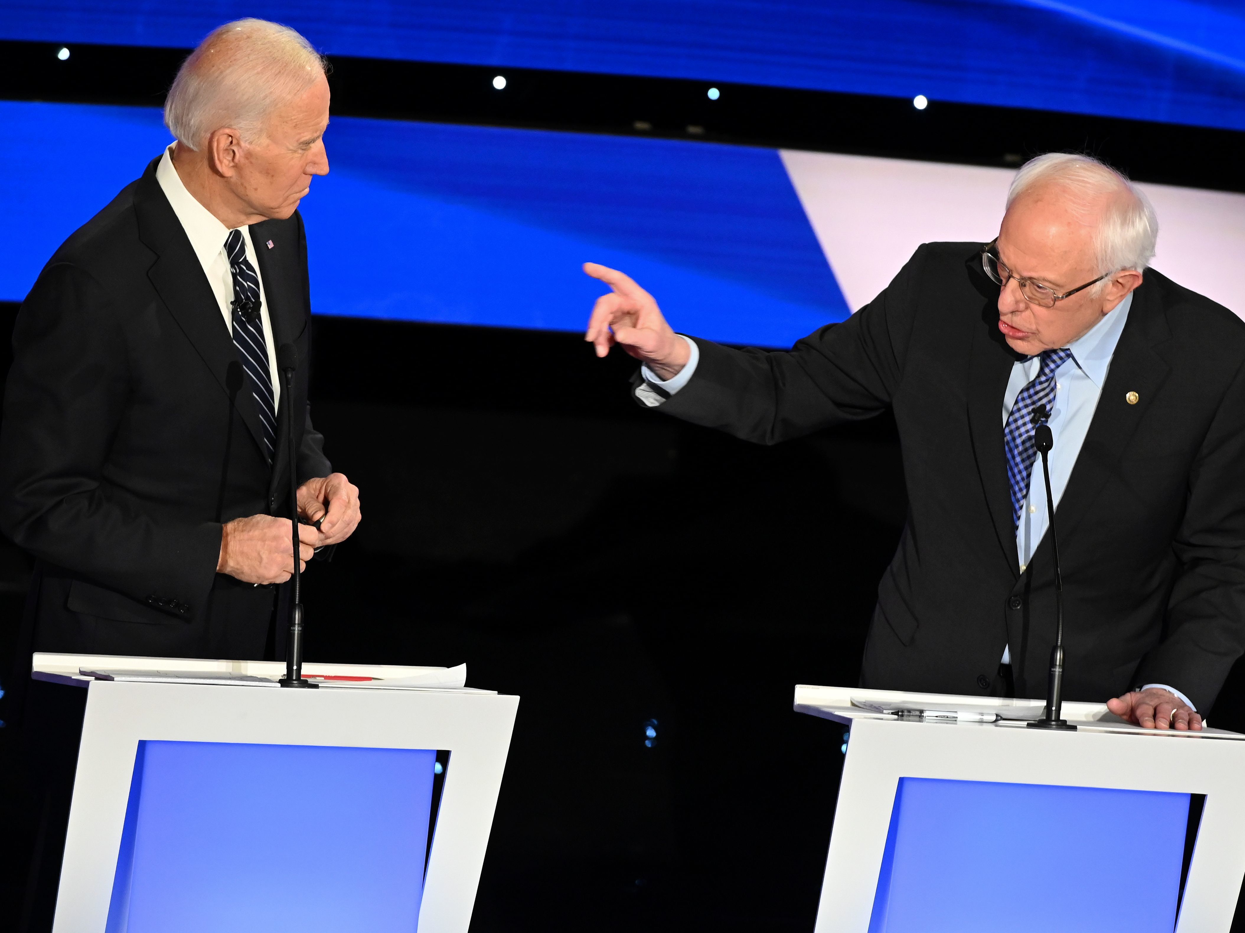 caption: Former Vice President Joe Biden, left, and Vermont Sen. Bernie Sanders participate in a Democratic presidential primary debate in Des Moines, Iowa, on Jan. 14. The two septuagenarians have sparred in recent days about Social Security.