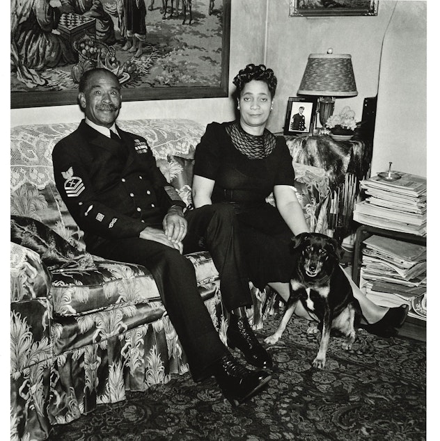 caption: Faye Alice and John Henry 'Dick' Turpin at their home around 1944. Dick Turpin was a World War I veteran, the Navy's first Black chief petty officer. He worked at the Bremerton shipyard where Al Smith, who photographed them here, also worked.