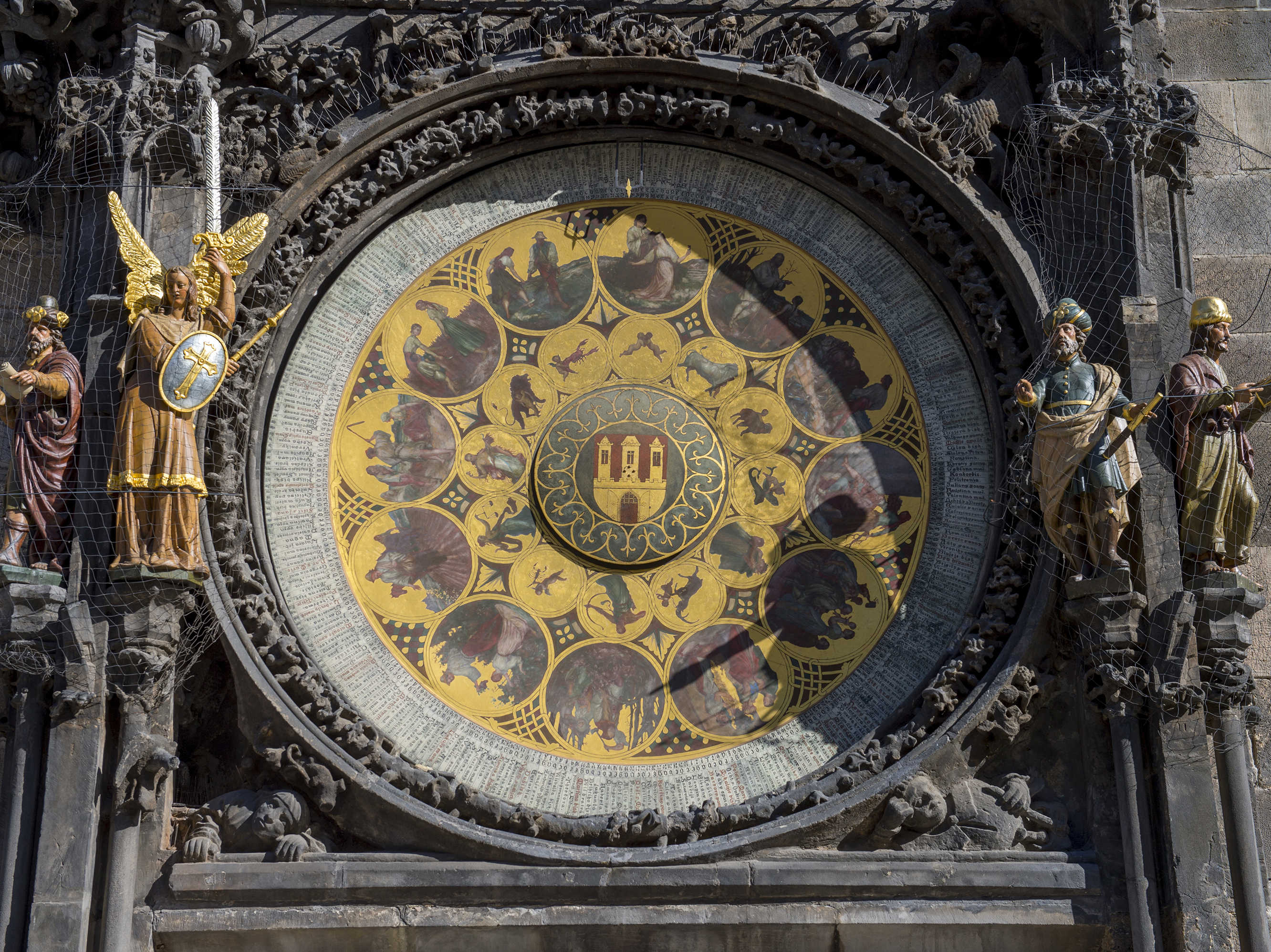 caption: The clock announces every hour with 12 apostles passing by the window above the astronomical dial and with symbolic sculptures moving aside.